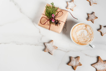 Wall Mural - Christmas breakfast, coffee mug with gingerbread star cookies, with christmas gift or present, on white wooden table top view copy space