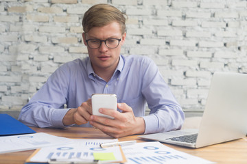 smart businessman working with smartphone in office