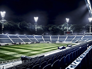 Wall Mural - empty soccer stadium in light rays at night