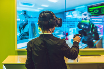 Young man playing video games virtual reality glasses. Cheerful man having fun with new trends technology - Gaming concept