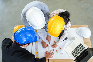 Hat engineer,Team of engineers discussing a blueprint