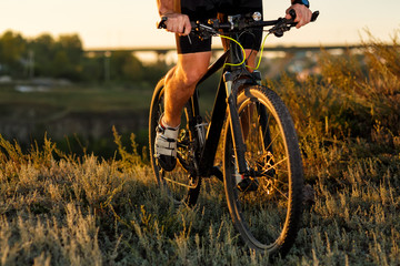 Wall Mural - Bike adventure travel photo. Cyclist on the Beautiful Meadow Trail on sunny day.