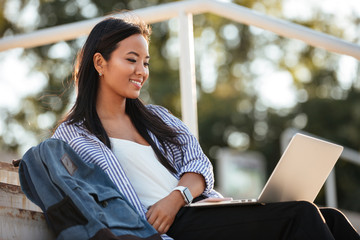 Poster - Portrait of a cheerful pretty asian female student