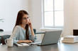 © bnenin - Attractive brunette woman writer sitting at the table and writing on the laptop computer.
