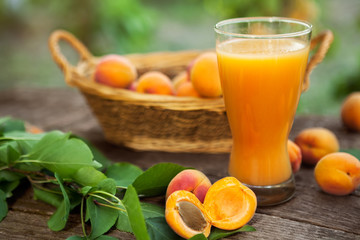 Wall Mural - Sliced apricots and apricot juice in glass