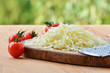 Grated mozzarella cheese and cherry tomatoes