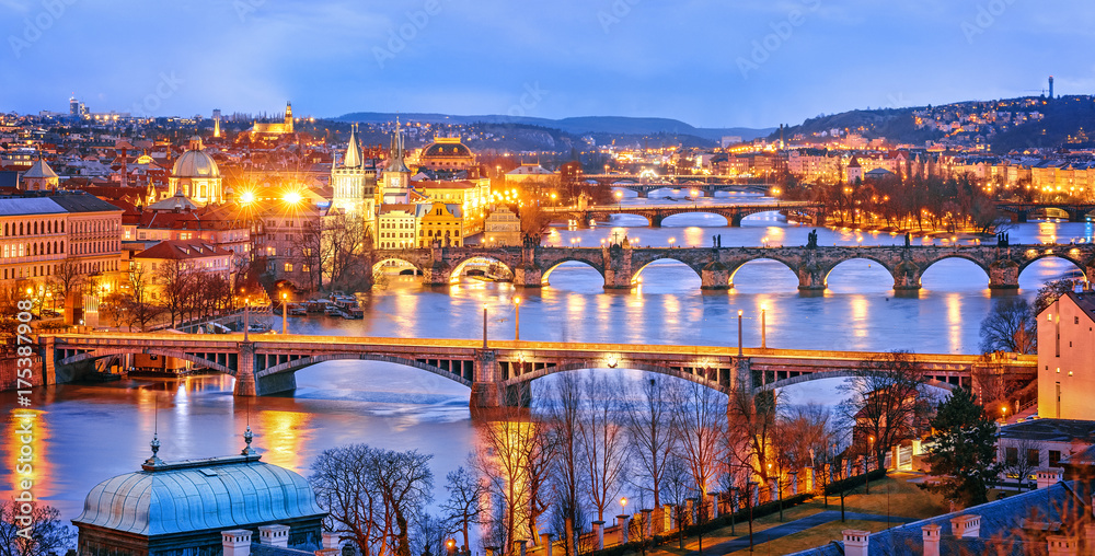 Classic view of Prague at Twilight, panorama of Bridges on Vltava, view from above, beautiful bridges vista. Winter scenery. Prague is famous and extremely popular travel destination. Czech Republic. - obrazy, fototapety, plakaty 
