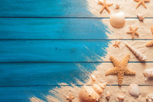Beach Scene Concept With Sea Shells And Starfish On A Blue Wooden Background