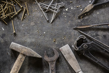 Different Hand Tools, Nails And Screws On Dark Metal Background