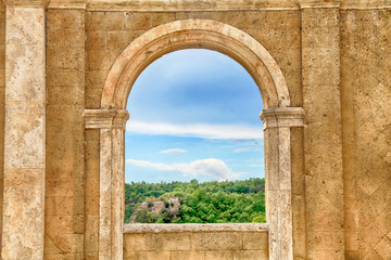 Wall Mural - Italian view through the arch window, Tuscany, Italy