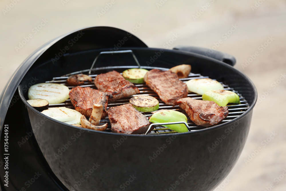 Barbecue grill with tasty steaks and vegetables, closeup
