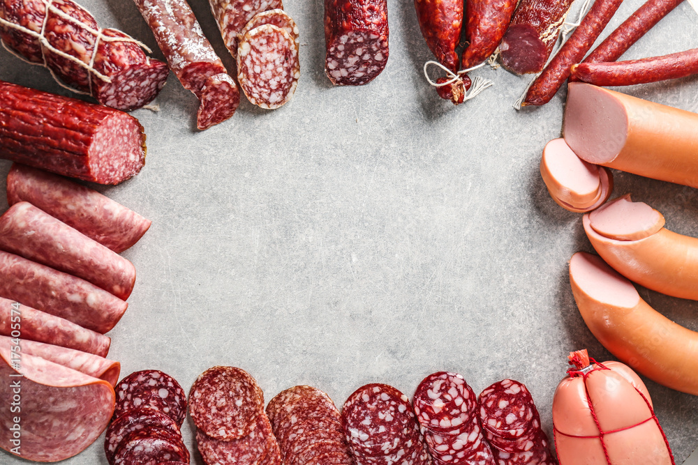 Assortment of sausages on grey background