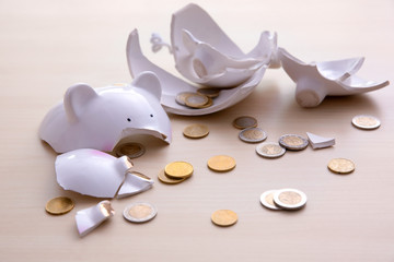 Poster - Broken piggy bank with coins on light background