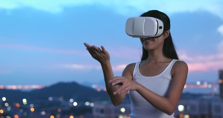 Wall Mural - Woman playing game on VR device