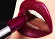 Trend Lips Makeup with bright dark Color Lipstick. Woman Applying Fashion lip Make-up. Choice lipstick