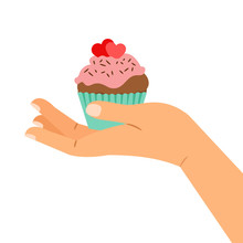 Hand Holding Cupcake With Two Hearts