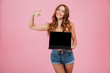 © Drobot Dean - Photo of beautiful readhead woman showing blank laptop computer screen and pointing at him