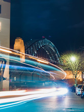 Trails Of Car Light With Sydney Harbour Bridge On The Background.