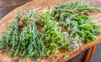 Wall Mural - Fresh herbs on the wooden table.