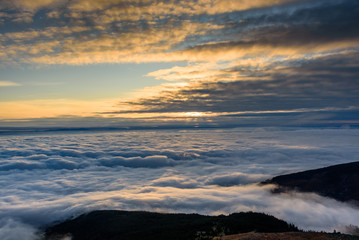 Poster - Cloud inversion from a mountain top - beautiful autumn landscape with thick blanket of rolling clouds at sunrise