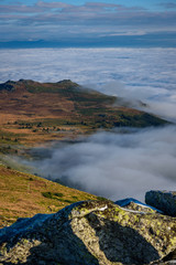 Poster - Cloud inversion from a mountain top - beautiful autumn landscape with thick blanket of rolling clouds at sunrise