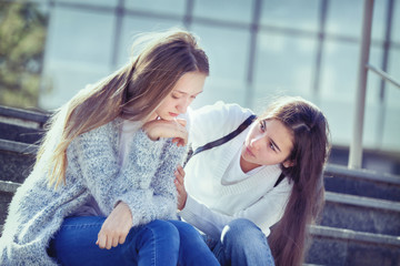 Sad Teenager cries, her girlfriend sympathizes