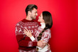 © deagreez - Portrait of adorable sweet family hugging and look into eyes of each other with such love and care, grin, in knitted cute traditional x mas wear with ornament, lady has braided  brunette hair