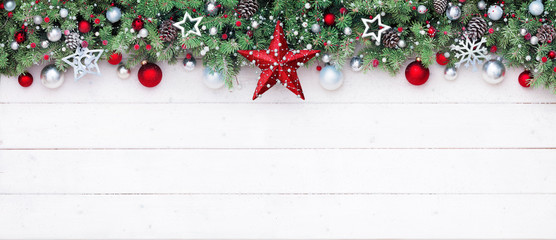 fir branches and decoration on white plank - christmas border