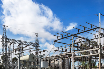               High voltage electrical pylon in electric power plants power substation on blue sky background  