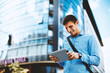 © djile - Young businessman using digital tablet in the downtown