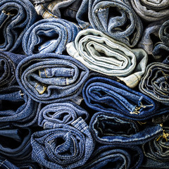 Canvas Print - Background close up of stack denim jeans fabric