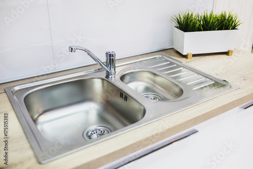 Fotomural A metal faucet with a sink in the new kitchen.