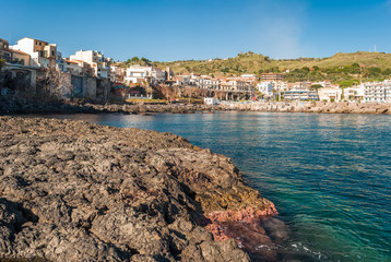 Wall Mural - Rocky coastline with typical pillows lava in the town of Aci Castello, in Sicily