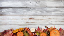 Bottom Border Of Autumn Foliage With Other Fall Decorations On White Rustic Wooden Boards For Thanksgiving Holiday Season 