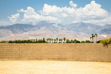 Looking Beyond A Brick Wall In Palm Springs With The Famous Wind Turbines In The Background