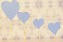 Four Blue Heart Paper With Wooden Stick On Blue Background