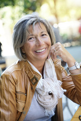 Wall Mural - Portrait of smiling active senior woman at coffee shop