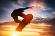 © Photocreo Bednarek - Skateboarder jumping at sunset.