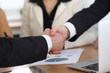 © rogerphoto - Close up of business people shaking hands at meeting or negotiation in the office. Partners are satisfied because signing contract
