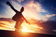 © Photocreo Bednarek - Man skateboarding at sunset.