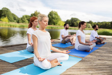 People Meditating In Yoga Lotus Pose Outdoors