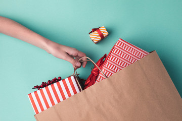 Canvas Print - hand holding paper bag with presents