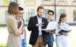 © A Stock Studio - Teacher and group of students outdoors near the university. Training.