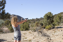 Woman Shooting A Handgun In The Desert