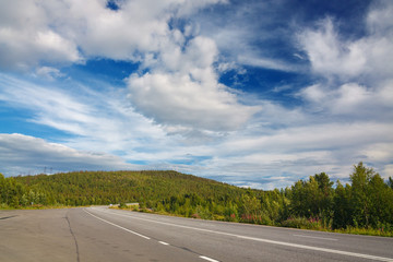 Highway with markings on the sky background.