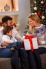 Wall Mural - Winter holiday - family enjoying in Christmas present.