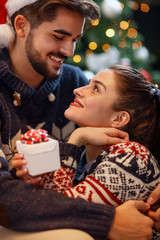 Wall Mural - Christmas couple enjoying in the holidays.