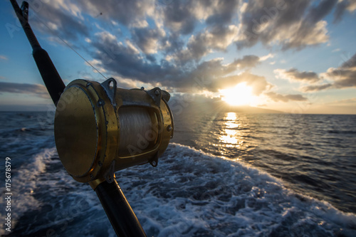 Fotografie, Obraz Deep Sea Fishing Reel on a boat during sunrise