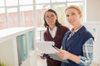 © pressmaster - Experienced accountant and her young assistant reading business papers in office