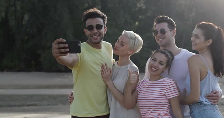 Wall Mural - People Taking Selfie Photo Together On Beach, Young Friends Group Posing Outdoors Natural Light Slow Motion 60